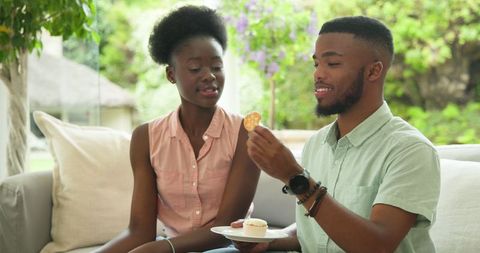 African Americans Enjoying Cupcakes on Sunny Outdoor Patio