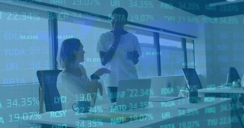 Colleagues discuss digital data strategy in modern office