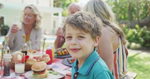 Family Backyard Gathering with Joyful Young Boy - Download Free Stock Images Pikwizard.com
