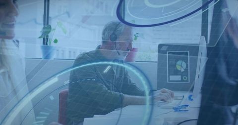 Mature professional working with headset at modern office desk with data dashboard overlay