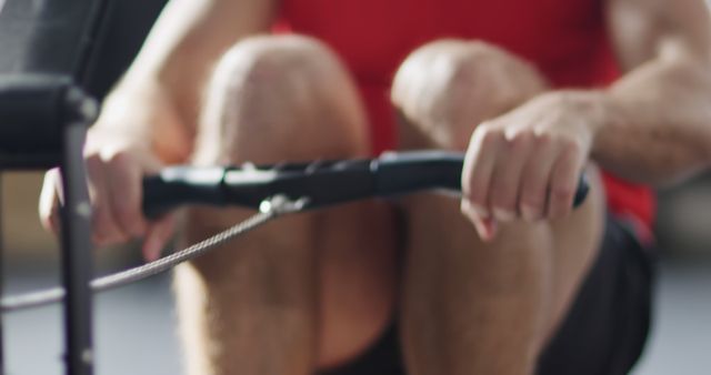 Man exercising on rowing machine in gym for fitness training - Download Free Stock Images Pikwizard.com