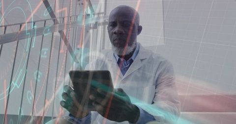 African american doctor using tablet with augmented data overlays in medical clinic