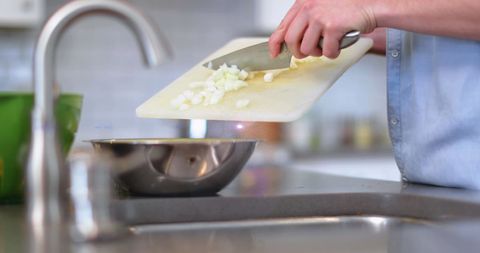 Man Preparing Ingredients in Modern Kitchen Setting