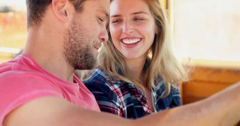 Happy Couple Enjoying Ride with Shared Laughter and Smiles