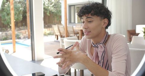 Young Adult with Pen Enjoying Relaxation by Natural Light