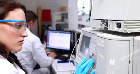 Female Scientist Conducting Laboratory Experiment with Advanced Equipment