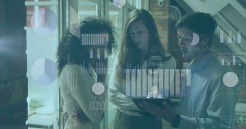 Business Professionals Analyzing Data on Tablet in Modern Office Environment