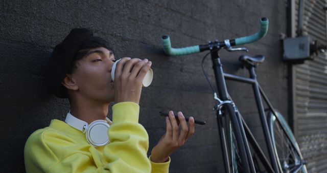 Young Man Relaxing with Coffee and Bike in Urban Setting - Download Free Stock Images Pikwizard.com