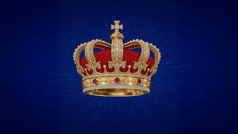 Luxurious british empire golden crown with ruby embellishments on blue background