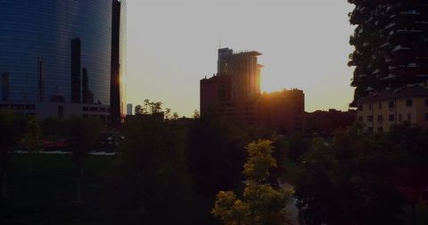 Sunset Over Modern Urban Cityscape with Tall Buildings