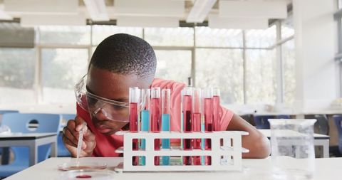 Curious youth conducting science experiment with test tubes