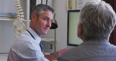 Doctor Consulting Senior Patient During Pandemic at Retirement Home