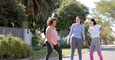 Diverse Friends Laughing Together in Active Wear Outdoor Fitness