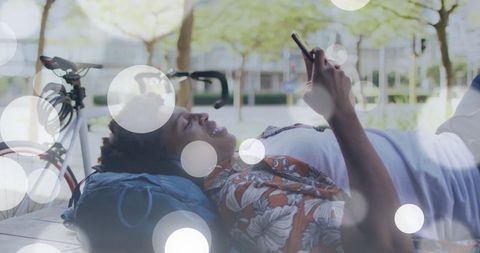 Relaxed young adult using smartphone outdoors at university campus