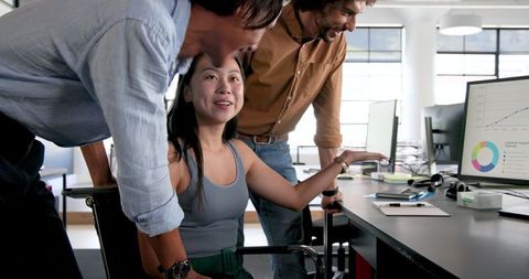 Colleagues Collaborating on Office Project with Computer Analysis