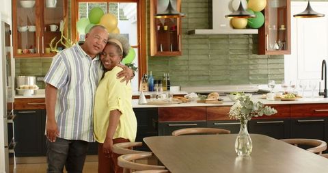 Senior Couple Embracing in Festively Decorated Kitchen