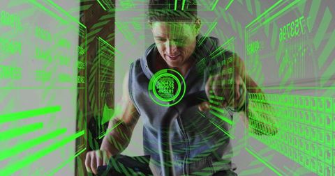 Mid-adult man cycling and reaching for neon augmented reality hud on indoor trainer