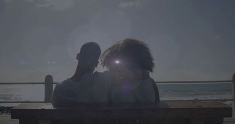 Romantic couple enjoying peaceful seaside sunset