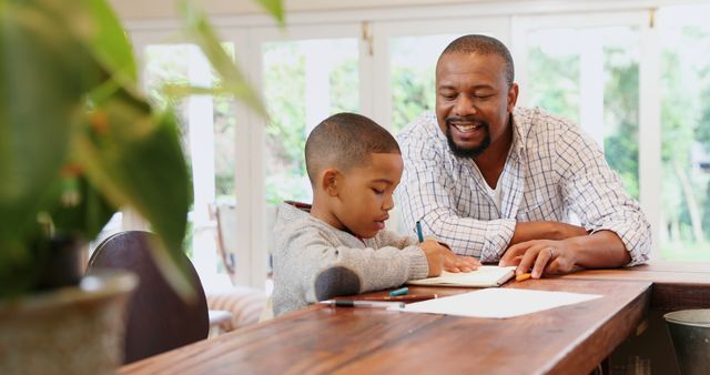 Father Helping Son with Homework in Bright Relaxed Setting - Download Free Stock Images Pikwizard.com