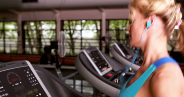 Woman Exercising on Treadmill with Headphones in Modern Gym - Download Free Stock Images Pikwizard.com