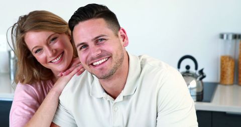 Playful Smiling Couple Relaxing Together at Home