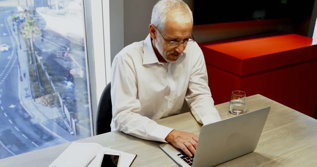 Senior Man Working on Laptop in Modern Office - Download Free Stock Images Pikwizard.com