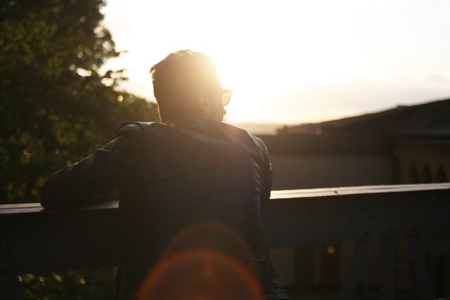 Pensive Man Enjoying Sunset on Rooftop Balcony - Download Free Stock Photos Pikwizard.com
