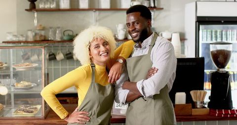 Diverse Barista Team Confidently Posing in Cozy Café Atmosphere