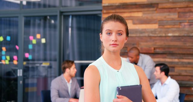 Confident Businesswoman Holding Tablet in Modern Office Environment - Download Free Stock Images Pikwizard.com