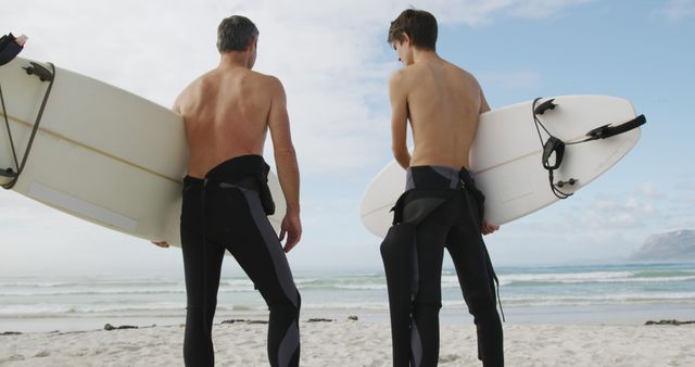 Father and Son Bonding Time Carrying Surfboards on Beach - Download Free Stock Images Pikwizard.com