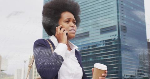 Urban Professional Talking on Phone Holding Coffee in Front of Glass Office Tower