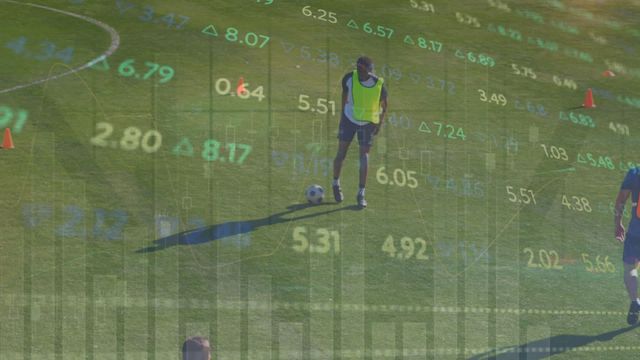 Financial stock data is visually overlaid on a scene featuring male soccer players training on a sports field. This blend of finance and sports imagery conveys themes of strategy, performance, and analysis. Ideal for use in content related to the economic aspects of sports, investment in athletics, or strategic business decision-making tutorials.