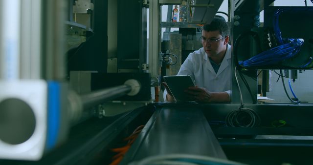 Engineer working with industrial equipment in high-tech manufacturing facility - Download Free Stock Images Pikwizard.com