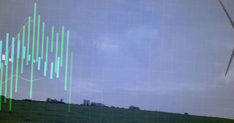 Wind turbine blade cutting cloudy sky with green stock chart overlay above rural meadow