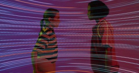 Women experiencing interactive exhibit with vibrant light patterns