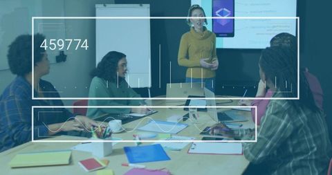 Presenting woman leading collaborative team meeting in modern conference room