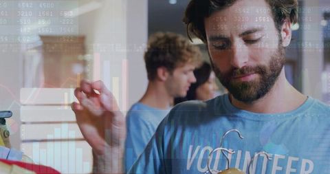 Volunteer sorting clothing and checking hanger in donation center with data overlay