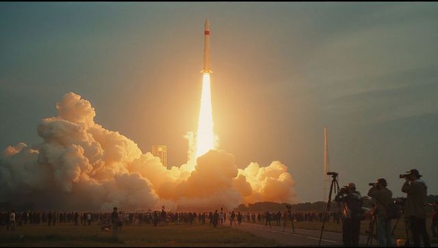 Rocket launch captured by photographers at dramatic dusk