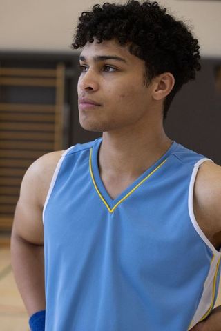 Focused athlete on basketball court in blue jersey