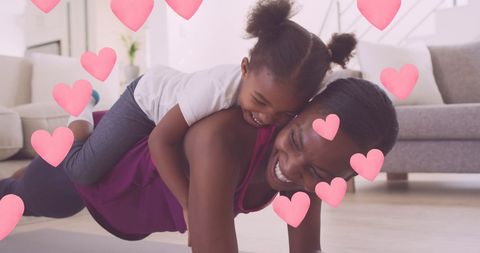 African American Mother and Daughter Exercising Together with Hearts