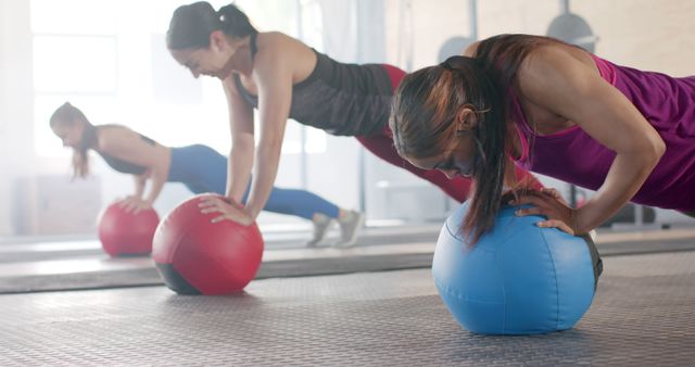 Women Engaging in Medicine Ball Push-Ups in Fitness Class - Download Free Stock Images Pikwizard.com