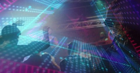 Cheering nightclub crowd raising hands and dancing under neon led beams and stage lights