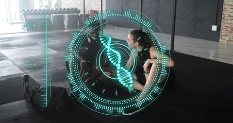 Workout partners checking fitness app with holographic dna scan in modern gym studio