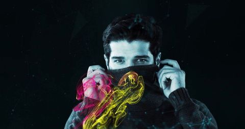 Mysterious man covering face with neon digital overlay