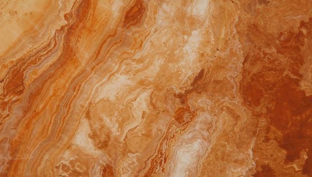 Rich rust and cream swirling natural stone surface