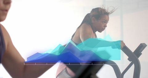 Diverse Women Exercising on Ellipticals with Data Overlay - Download Free Stock Images Pikwizard.com