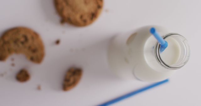 Image of glass bottle of milk and cookies on white background. dairy products and healthy organic nutrition.