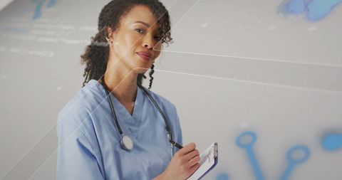 Clinician Holding Clipboard and Stethoscope Monitoring Digital Interface for Telemedicine