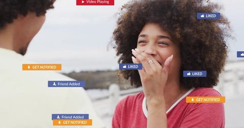 Laughing woman covering mouth on pier with social media notification overlays