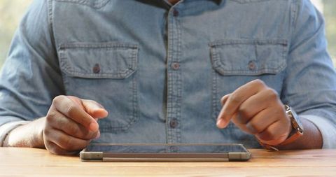 Man Engaged with Tablet in Casual Setting